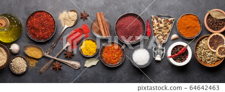 Various spices in bowls and spoons 64642463