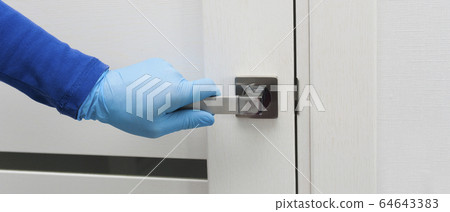 Mens hand in a blue protective gloves opens or close the door. Antibacterial prophylaxis banner in times of viruses and infections. Health and protection concept 64643383