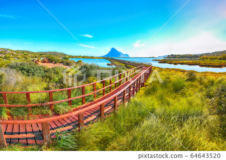 Sunrise from a pedestrian walkway to Porto Taverna 64643520
