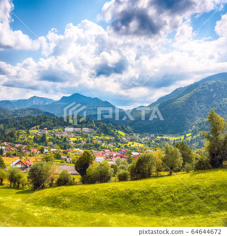 Stunning alpine landscape with green fields and 64644672