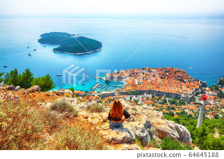 Happy girl enjoys view of old town (medieval Happy girl enjoys view of old town (medieval 64645188