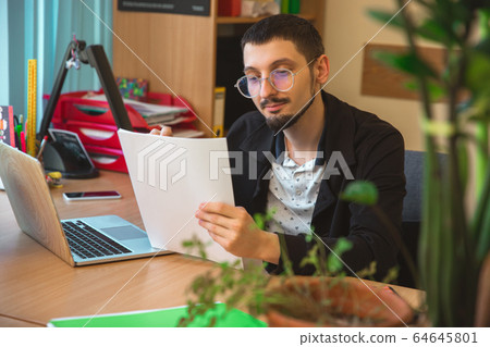 Caucasian entrepreneur, businessman, manager working concentrated in office Caucasian entrepreneur, businessman, manager working concentrated in office 64645801