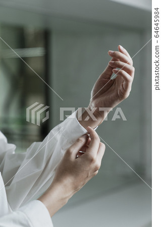 Cropped hand and sleeve. Cropped hand and sleeve. 64645984