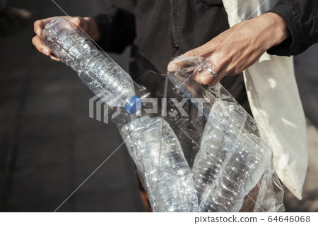 Picking up plastic bottle. Picking up plastic bottle. 64646068