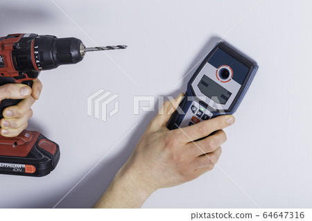 Man hand is scanning wall by cable detector to Man hand is scanning wall by cable detector to 64647316