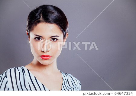 girl model posing in the Studio on a grey background 64647334