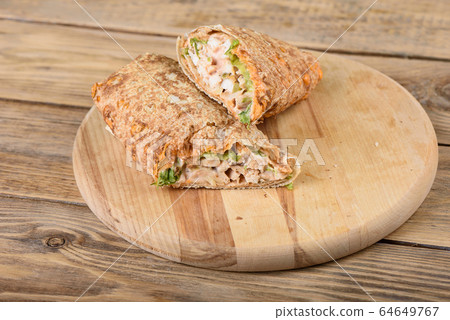 Shawarma Middle Eastern dish of pita bread, stuffed with grilled and then minced chicken meat. Shawarma Middle Eastern dish of pita bread, stuffed with grilled and then minced chicken meat. 64649767