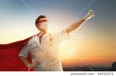 Doctor wearing facemask and superhero cape 64650074