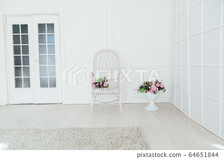 white chair with flowers in the interior of the white room 64651844