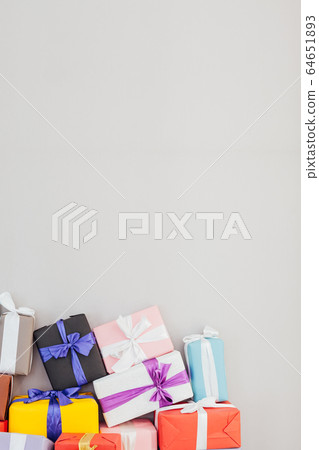 multicolored birthday presents on a grey background 64651893