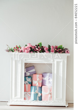 fireplace with flowers in the interior of the white room fireplace with flowers in the interior of the white room 64652221