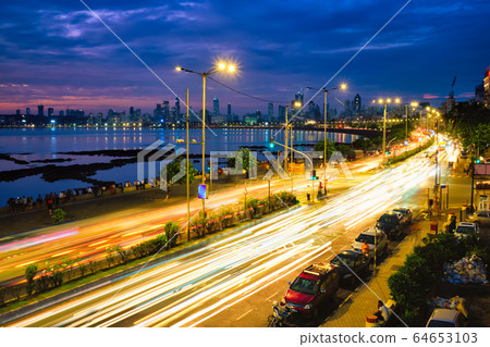 Marine drive in the night with car light trails. Mumbai, Maharashtra, India Marine drive in the night with car light trails. Mumbai, Maharashtra, India 64653103