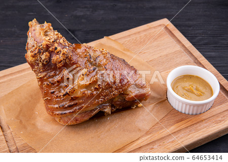 Rolls baked in an oven with spices are served with mustard 64653414