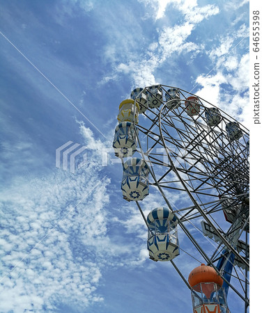 Ferris wheel on the background over blue sky 64655398