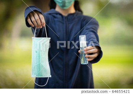 Asian child girl hold a mask and bottle of alcohol disinfectant or alcohol antiseptic gel to prevent infection of Covid-19,Coronavirus outbreak,hand sanitizer to protect against contagious disease Asian child girl hold a mask and bottle of alcohol disinfectant or alcohol antiseptic gel to prevent infection of Covid-19,Coronavirus outbreak,hand sanitizer to protect against contagious disease 64655421