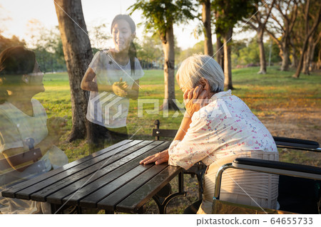 A lonely senior woman is waiting and thinking old memories of her family that will visit her again,depressed elderly people with loneliness and depression sitting alone,missing,nostalgia,remembrance A lonely senior woman is waiting and thinking old memories of her family that will visit her again,depressed elderly people with loneliness and depression sitting alone,missing,nostalgia,remembrance 64655733