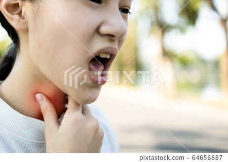 Sick asian child girl has sore throat,cough,hoarseness,laryngeal cancer,hand touch her neck,woman with throat problem,tonsillitis, loss of voice,infection of flu,colds,viruses,bacteria in the larynx Sick asian child girl has sore throat,cough,hoarseness,laryngeal cancer,hand touch her neck,woman with throat problem,tonsillitis, loss of voice,infection of flu,colds,viruses,bacteria in the larynx 64656887