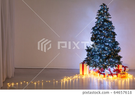 Christmas tree garland lights with new year holiday gifts December interior Christmas tree garland lights with new year holiday gifts December interior 64657618