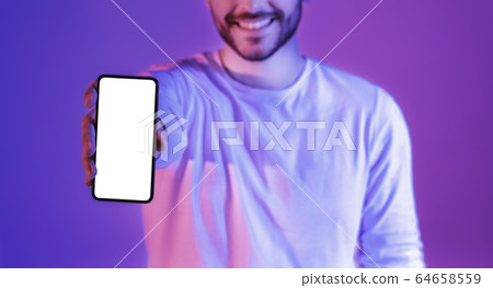 Share joy. Man shows smartphone with blank screen 64658559