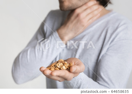 Suffocation concept. Allergic to nuts, free space Suffocation concept. Allergic to nuts, free space 64658635