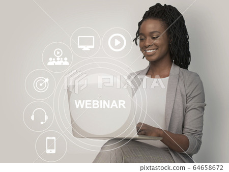 African American woman watching online webinar on laptop, collage with remote learning pictograms on screen 64658672