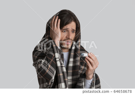 High fever during flu. Man with blanket High fever during flu. Man with blanket 64658678