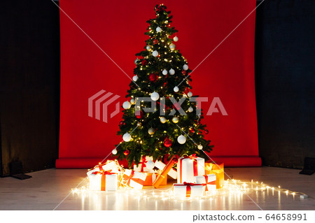Christmas tree with gifts garland new year interier red room 64658991