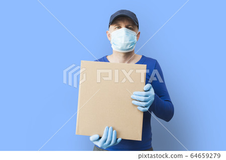 Delivery man holding cardboard boxes in medical rubber gloves and mask. copy space. Fast and free Delivery transport. Online shopping and Express delivery. Quarantine Delivery man holding cardboard boxes in medical rubber gloves and mask. copy space. Fast and free Delivery transport. Online shopping and Express delivery. Quarantine 64659279