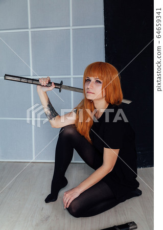 red-haired girl with a Japanese sword cosplayer anime Japan red-haired girl with a Japanese sword cosplayer anime Japan 64659341