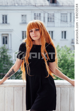red-haired girl with a Japanese sword cosplayer anime Japan red-haired girl with a Japanese sword cosplayer anime Japan 64659344