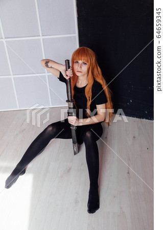 red-haired girl with a Japanese sword cosplayer anime Japan red-haired girl with a Japanese sword cosplayer anime Japan 64659345