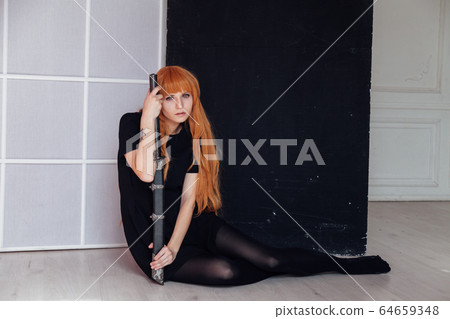 red-haired girl with a Japanese sword cosplayer anime Japan red-haired girl with a Japanese sword cosplayer anime Japan 64659348
