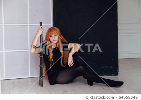 red-haired girl with a Japanese sword cosplayer anime Japan red-haired girl with a Japanese sword cosplayer anime Japan 64659349