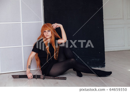 red-haired girl with a Japanese sword cosplayer anime Japan red-haired girl with a Japanese sword cosplayer anime Japan 64659350