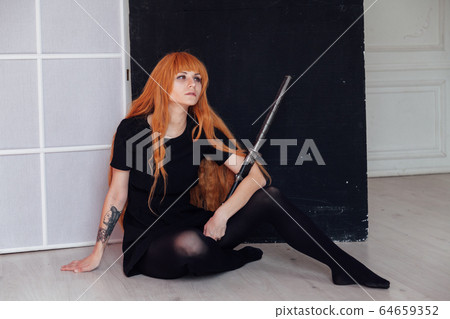 red-haired girl with a Japanese sword cosplayer anime Japan red-haired girl with a Japanese sword cosplayer anime Japan 64659352
