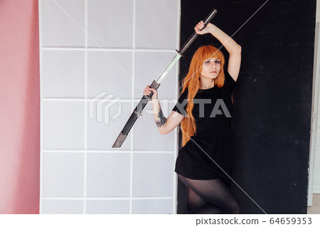 red-haired girl with a Japanese sword cosplayer anime Japan red-haired girl with a Japanese sword cosplayer anime Japan 64659353