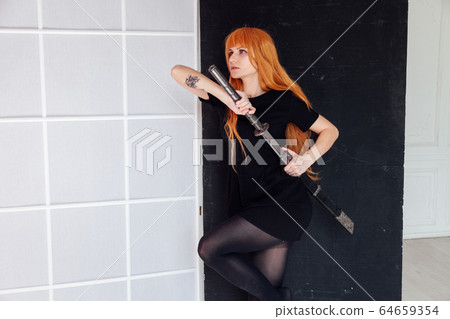 red-haired girl with a Japanese sword cosplayer anime Japan red-haired girl with a Japanese sword cosplayer anime Japan 64659354