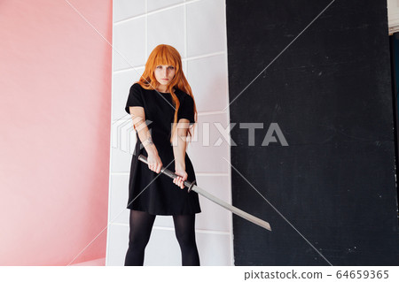 Portrait of a beautiful girl with a Japanese sword cosplayer anime Japan 64659365