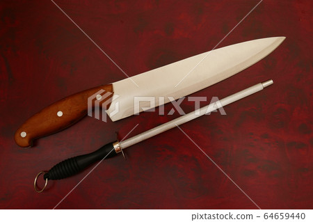Knife and Sharpener On A Cutting Board Knife and Sharpener On A Cutting Board 64659440