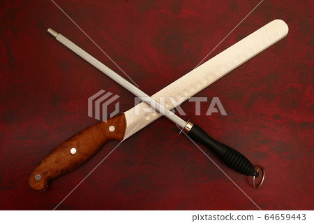 Knife and Sharpener On A Cutting Board Knife and Sharpener On A Cutting Board 64659443