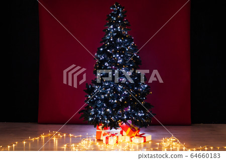 Christmas tree with gifts lights garlands for the new year Christmas tree with gifts lights garlands for the new year 64660183