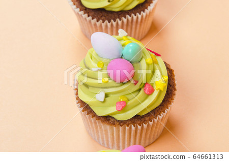 Easter pistachio cupcake with decorations 64661313