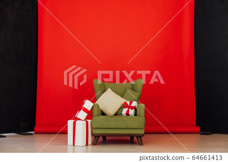 green vintage chair with gifts in the interior of the red room green vintage chair with gifts in the interior of the red room 64661413