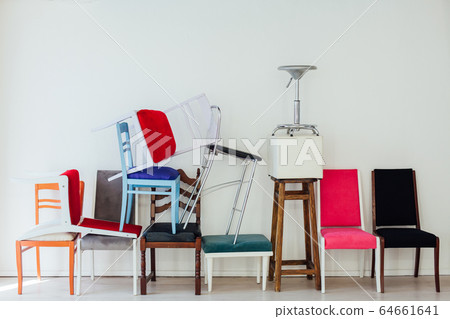 lots of multicolored chairs in the interior of the white room 64661641