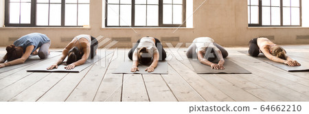 Girls doing Child Pose during yoga session Girls doing Child Pose during yoga session 64662210