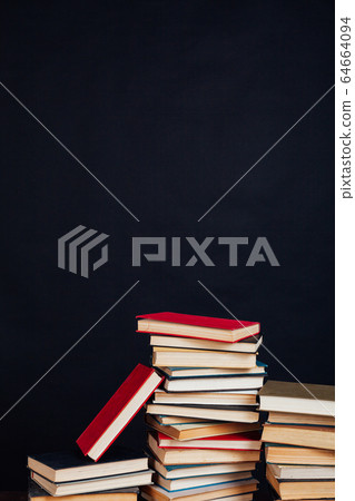 many stacks of educational books in the university library on a black background many stacks of educational books in the university library on a black background 64664094