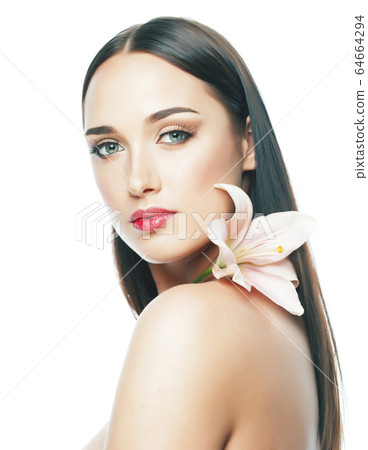 young attractive lady close up with hands on face isolated flower lily brunette spa nude makeup macro young attractive lady close up with hands on face isolated flower lily brunette spa nude makeup macro 64664294