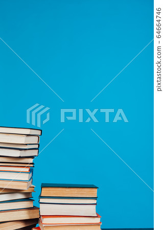 many stacks of educational books for learning preparation for college exams on a blue background many stacks of educational books for learning preparation for college exams on a blue background 64664746