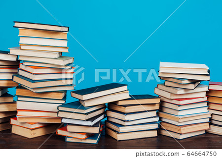 many stacks of educational books for learning preparation for college exams on a blue background many stacks of educational books for learning preparation for college exams on a blue background 64664750