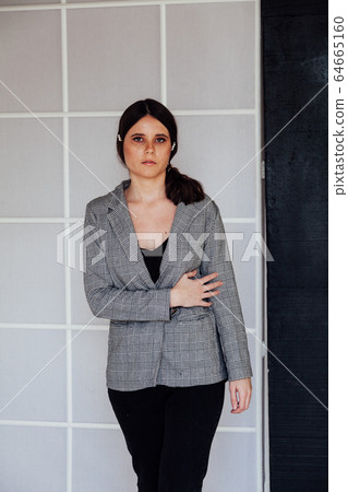portrait of a beautiful young fashionable woman in a business suit portrait of a beautiful young fashionable woman in a business suit 64665160
